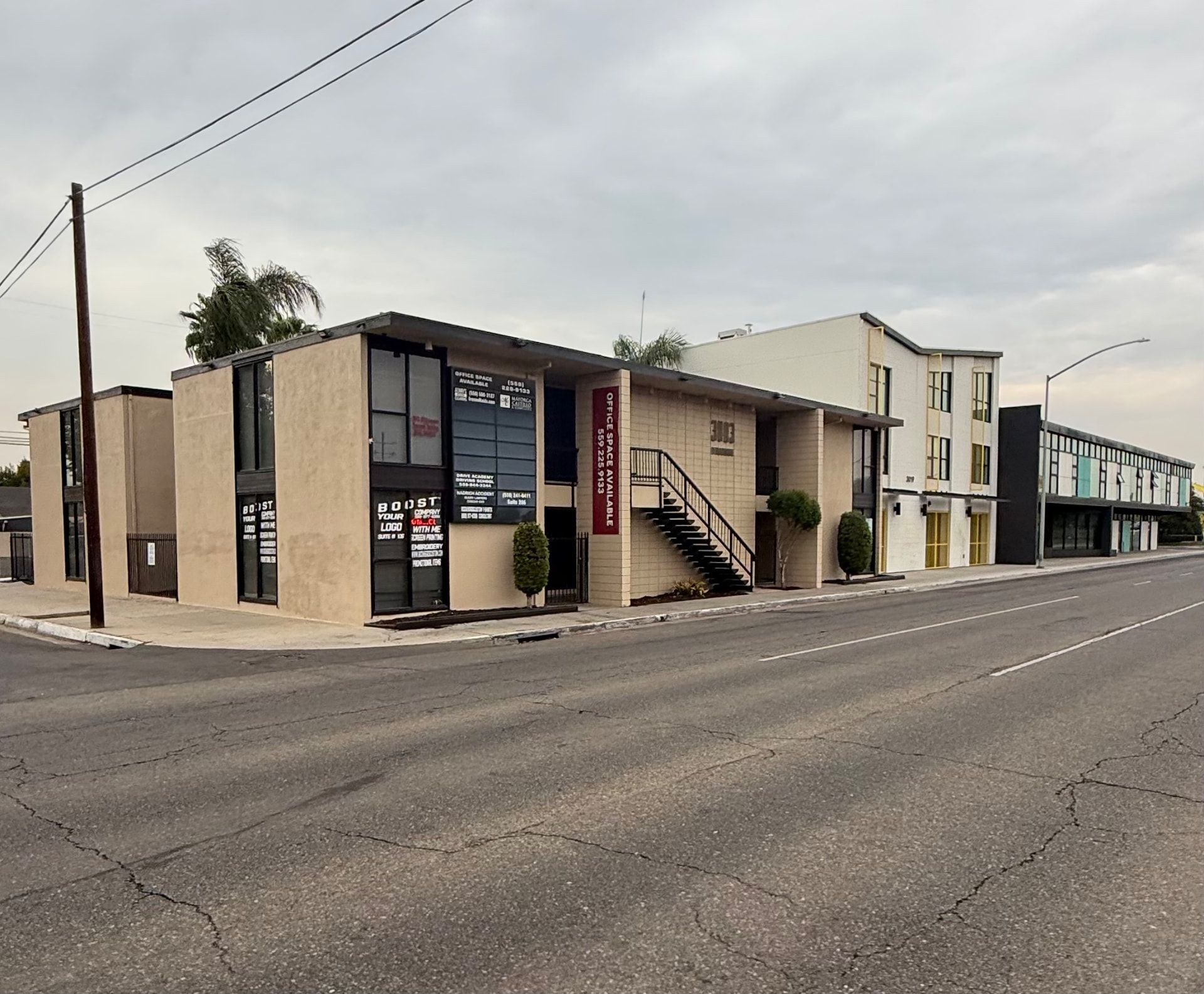 Corner view of a repainted commercial office complex with clean stucco walls